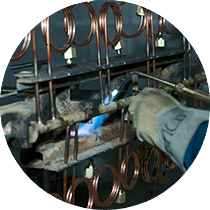 Une personne qui est entrain de souder une pièce manifold.